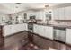 Bright kitchen featuring white cabinets, stainless steel appliances, and dark wood flooring at 402 W Patterson St, Lakeland, FL 33803