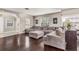 Spacious living room with dark hardwood floors, ample natural light, and a comfortable oversized sectional sofa at 402 W Patterson St, Lakeland, FL 33803