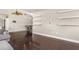 Bright living room with dark hardwood floors, fan, dining area, and floating shelves at 402 W Patterson St, Lakeland, FL 33803