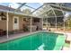 The screened in pool area features an outdoor kitchen, bar area and ample space for entertainment at 402 W Patterson St, Lakeland, FL 33803