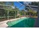 Screened-in pool provides a refreshing escape in a private backyard setting with lush landscaping at 402 W Patterson St, Lakeland, FL 33803
