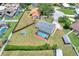 An aerial view shows a home with a screened in pool and lots of yard space at 404 Willow Run, Lakeland, FL 33813