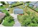 Aerial view of the property showcasing the home, large yard, screened-in pool, and surrounding neighborhood at 404 Willow Run, Lakeland, FL 33813