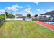 Backyard with shed, pool, screen area, and a white fence at 404 Willow Run, Lakeland, FL 33813
