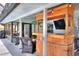 A screened patio has a custom bar with a stained-wood finish and a flatscreen TV at 404 Willow Run, Lakeland, FL 33813