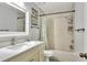 Bright bathroom featuring a shower-tub combo and a light vanity at 404 Willow Run, Lakeland, FL 33813