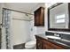 Modern bathroom featuring a tiled shower, a decorative mirror, and a dark vanity at 404 Willow Run, Lakeland, FL 33813