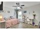 Inviting bedroom with a ceiling fan, desk, and window at 404 Willow Run, Lakeland, FL 33813