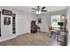 A light-filled bedroom features wood floors, a ceiling fan, and a closet at 404 Willow Run, Lakeland, FL 33813