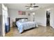 Bright bedroom with a ceiling fan, hardwood flooring, and closet space at 404 Willow Run, Lakeland, FL 33813