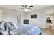 Serene bedroom featuring a ceiling fan and access to the en suite bathroom at 404 Willow Run, Lakeland, FL 33813