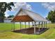 Exterior view of a covered wood structure with grassy lawn and fence at 404 Willow Run, Lakeland, FL 33813