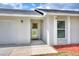 Welcoming entrance showcasing a bright yellow framed door, white trim, and clean, modern exterior design at 404 Willow Run, Lakeland, FL 33813