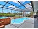 A screened-in pool and hot tub area with deck-style stairs for easy access at 404 Willow Run, Lakeland, FL 33813