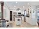 Bright kitchen with white cabinets, stainless appliances, a center island, and tiled floors for easy maintenance at 404 Willow Run, Lakeland, FL 33813