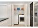 Neat laundry area with modern washer and dryer, plus shelving for storage at 404 Willow Run, Lakeland, FL 33813