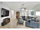 Comfortable living room with tile flooring, a large gray sectional, and entertainment center at 404 Willow Run, Lakeland, FL 33813