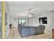 Spacious living room with tile flooring, a ceiling fan, and a large sectional sofa at 404 Willow Run, Lakeland, FL 33813