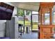 A screened patio has a small stainless refrigerator, a grill, and an outdoor bar at 404 Willow Run, Lakeland, FL 33813