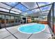 Beautiful screened-in pool with hot tub and an outdoor bar, perfect for entertaining guests at 404 Willow Run, Lakeland, FL 33813