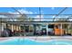 A lovely view of the screened in pool area with outdoor seating, bar, and dining space at 404 Willow Run, Lakeland, FL 33813