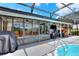 A sunny outdoor pool has a surrounding screened enclosure and plenty of lounge space at 404 Willow Run, Lakeland, FL 33813