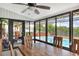 A sunroom features large windows looking out to the pool and patio area at 404 Willow Run, Lakeland, FL 33813