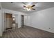 Spacious bedroom featuring vinyl floors, ceiling fan, and mirrored closets at 409 San Jose Dr, Winter Haven, FL 33884