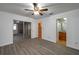 Bright bedroom featuring modern gray wood-look flooring, ceiling fan, and sliding door closet at 409 San Jose Dr, Winter Haven, FL 33884