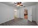 Bright bedroom featuring modern gray wood-look flooring, closet and open doorway to kitchen at 409 San Jose Dr, Winter Haven, FL 33884