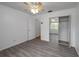 Bedroom featuring modern gray wood-look flooring, ceiling fan and mirrored closet at 409 San Jose Dr, Winter Haven, FL 33884