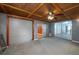 Spacious garage with gray walls, wood ceiling and doors to living areas at 409 San Jose Dr, Winter Haven, FL 33884