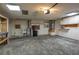 Spacious garage featuring overhead lighting, a sink, storage cabinets, water heater, and ample space for parking at 409 San Jose Dr, Winter Haven, FL 33884