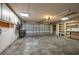 Spacious garage with overhead lighting, ample storage shelving, work bench area, and an automatic door system at 409 San Jose Dr, Winter Haven, FL 33884