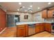 Well-equipped kitchen with stainless steel appliances, wood cabinets, and a breakfast bar at 409 San Jose Dr, Winter Haven, FL 33884