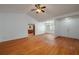 Spacious living room with wood floors, white walls, and a ceiling fan at 409 San Jose Dr, Winter Haven, FL 33884