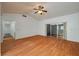 Well-lit living room featuring laminate wood floors, white walls, and a sliding door to the patio at 409 San Jose Dr, Winter Haven, FL 33884