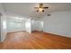 Spacious living room featuring wood floors, white walls, and a ceiling fan at 409 San Jose Dr, Winter Haven, FL 33884