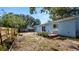 Charming backyard with a quaint porch swing on the back of a light blue home at 417 Yolonda Ct, Lakeland, FL 33809