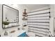Decorated bathroom featuring a vanity and a patterned shower curtain at 417 Yolonda Ct, Lakeland, FL 33809