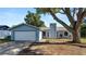 Charming single-story home with a well-maintained lawn, a two-car garage and mature shade tree at 417 Yolonda Ct, Lakeland, FL 33809