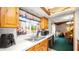 This kitchen has wooden cabinets and a sink beneath a large window at 417 Yolonda Ct, Lakeland, FL 33809
