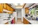 The bright kitchen features white appliances and wooden cabinets at 417 Yolonda Ct, Lakeland, FL 33809