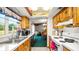 Well lit kitchen with wooden cabinets and view into the dining room at 417 Yolonda Ct, Lakeland, FL 33809
