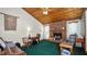 Cozy living room featuring a brick fireplace, wood ceiling, and ample natural light at 417 Yolonda Ct, Lakeland, FL 33809