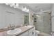 Bathroom with double sink vanity and glass-enclosed shower at 4582 Penkert Pl, Lakeland, FL 33811