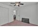 Simple bedroom featuring a ceiling fan, closet, and doorway, offering functionality at 4582 Penkert Pl, Lakeland, FL 33811