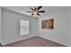Bright bedroom with window, ceiling fan, neutral walls, and carpet flooring providing a cozy feel at 4582 Penkert Pl, Lakeland, FL 33811