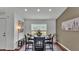 Bright dining area with a modern table set, recessed lighting, and a view to the outdoors at 4582 Penkert Pl, Lakeland, FL 33811