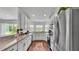 Well-lit kitchen with white cabinets, stainless steel appliances, and backyard view at 4582 Penkert Pl, Lakeland, FL 33811